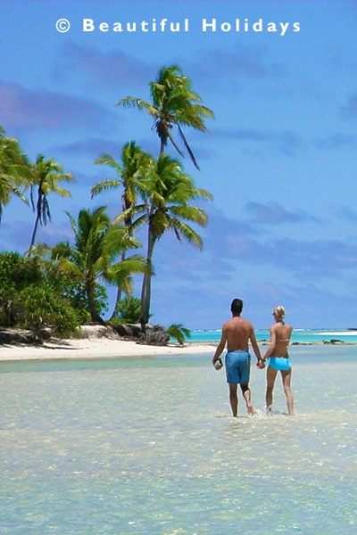 couple stroll in the lagoon off One Foot Island in Aitutaki