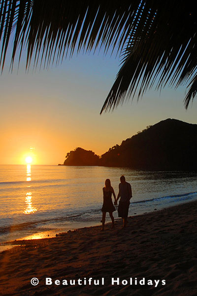 couple enjoy romantic sunset on honeymoon in fiji