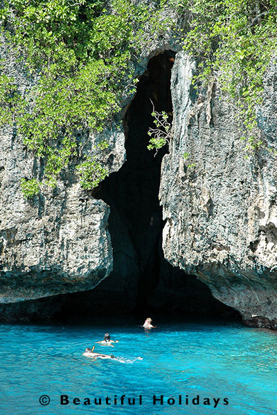 tourists snorkelling at swallows cave in vavau
